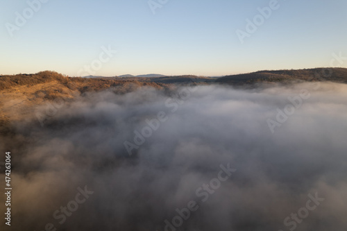 Fototapeta Naklejka Na Ścianę i Meble -  Aerial photography over the clouds in the mountains