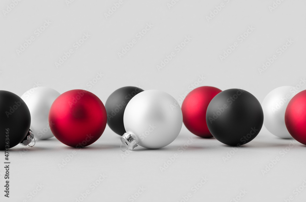 Multiple white, red and black matte Christmas balls mockup on a seamless grey background. Multiple white, red and black matte Christmas balls mockup on a seamless grey background.