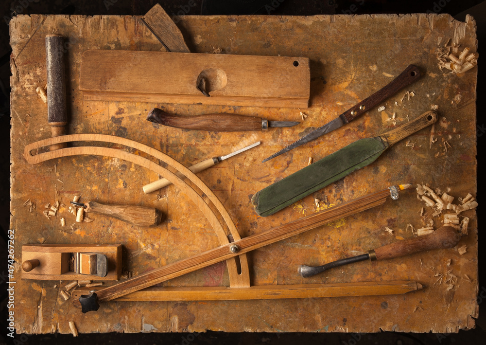 Hand tools Wood on an old wooden workbench (Drill Jig Saw plane chisel) occupation concept Hand tools Wood on an old wooden workbench (Drill Jig Saw plane chisel) occupation concept