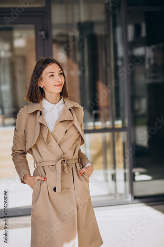 Young beautiful woman wearing coat walking in the city © Petro