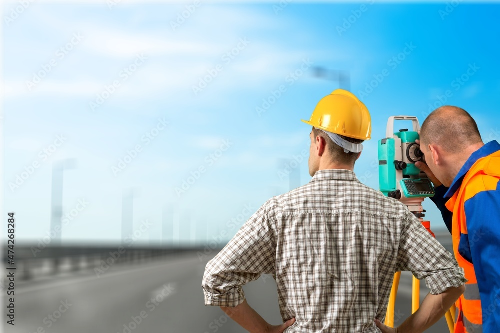 Teamwork of surveyor engineers worker making measuring on road works. survey engineer Teamwork of surveyor engineers worker making measuring on road works. survey engineer