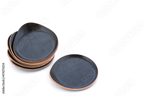 Set of black rustic wooden drink coasters isolated on white background with space for text
