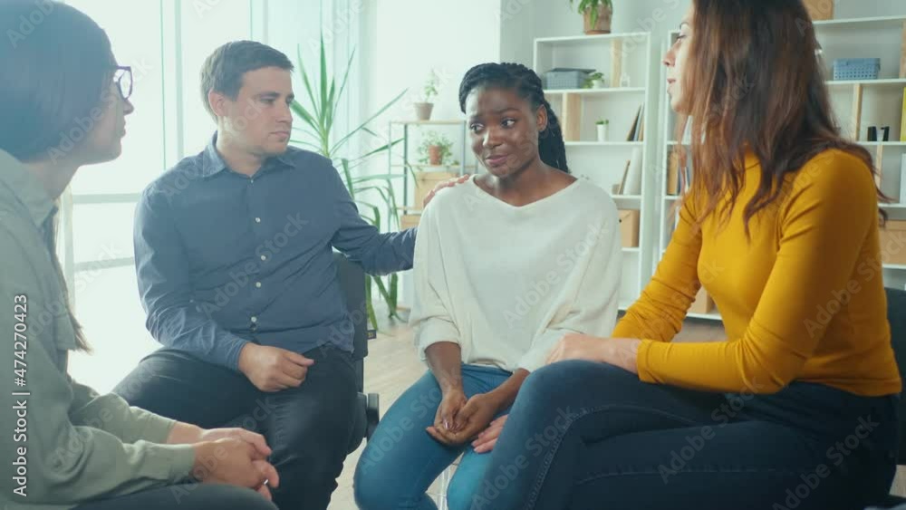 African American Woman Shares Her Personal Addiction Problem, Emotional Pain, Receives Psychological Support, Compassion, Empathy From People in a Group Therapy Session. Abuse, Violence, Depression. African American Woman Shares Her Personal Addiction Problem, Emotional Pain, Receives Psychological Support, Compassion, Empathy From People in a Group Therapy Session. Abuse, Violence, Depression.