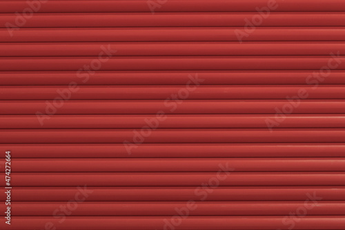 Old texture of red external blinds on windows. Painted wooden surface. close up