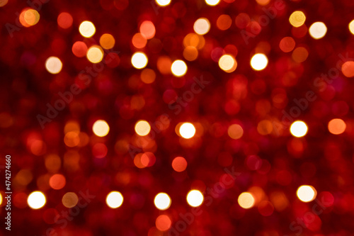 Festive red sparkling bokeh background with shiny sparkles and colorful dots as perfect background for Christmas, silvester, celebration and happy new year annotations as beautiful blurred glow