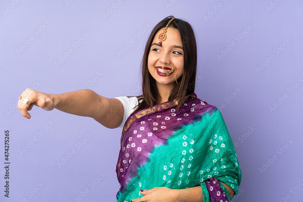 Young Indian woman isolated on purple background giving a thumbs up gesture Young Indian woman isolated on purple background giving a thumbs up gesture