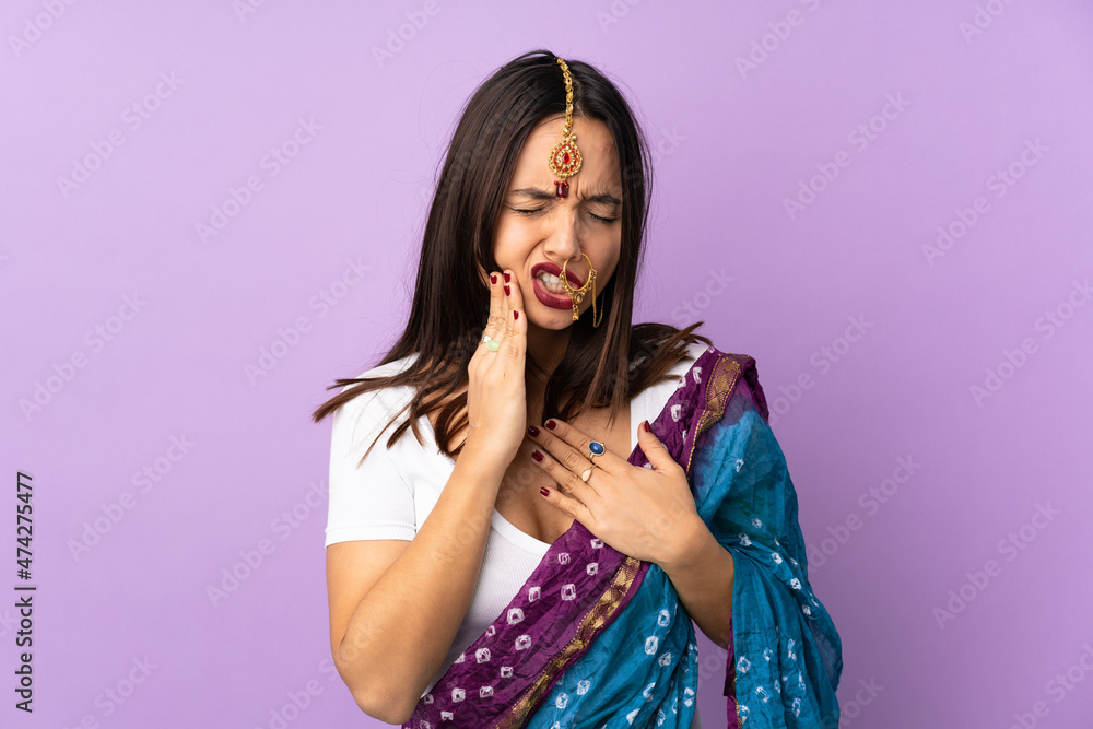 Young Indian woman isolated on purple background with toothache Young Indian woman isolated on purple background with toothache