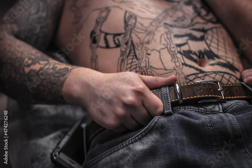 Professional tattooist makes a tattoo in a tattoo parlor