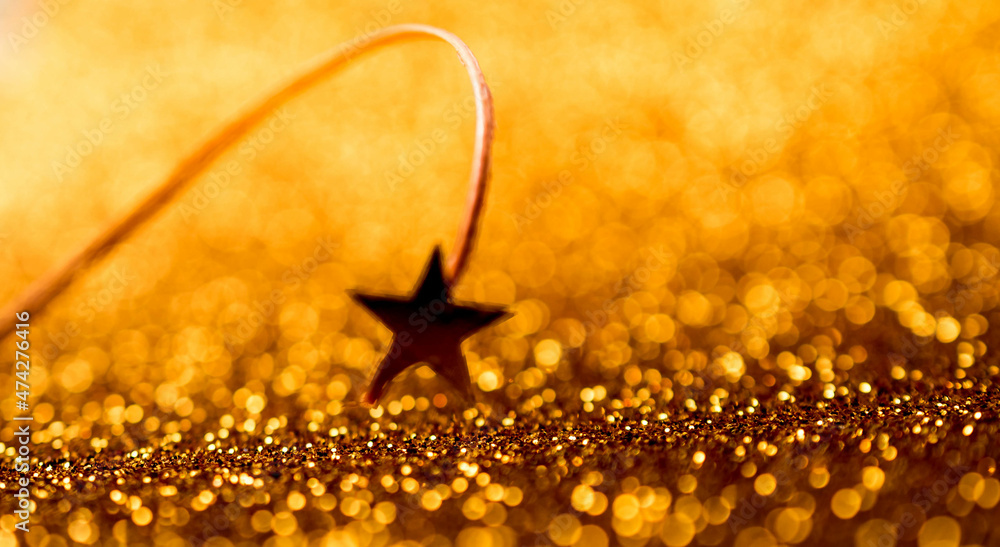 Golden stars on a gold background, Shiny sparkling gold background with copy space