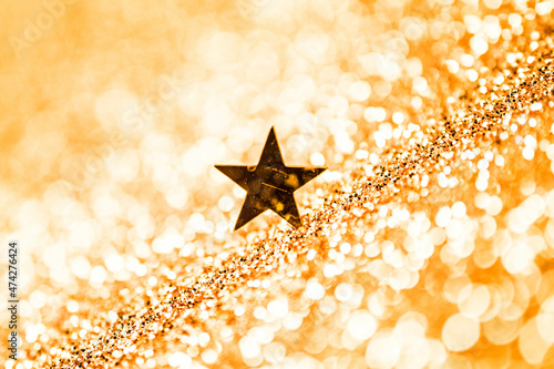 Obraz na płótnie Golden stars on a gold background, Shiny sparkling gold background with copy space. w salonie