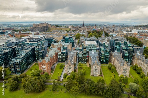 Stunning aerial view of Edinburgh in Scotland, with the castle dominates the skyline, casting its shadow over the surrounding historic town occupying commanding position on volcanic crag with cliffs © Damian