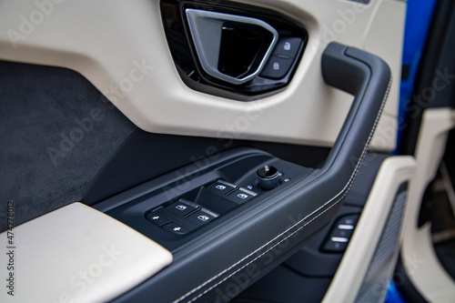 Interior of modern car. Side door buttons: window, mirror adjustment buttons, door lock. Car inside. © Maria