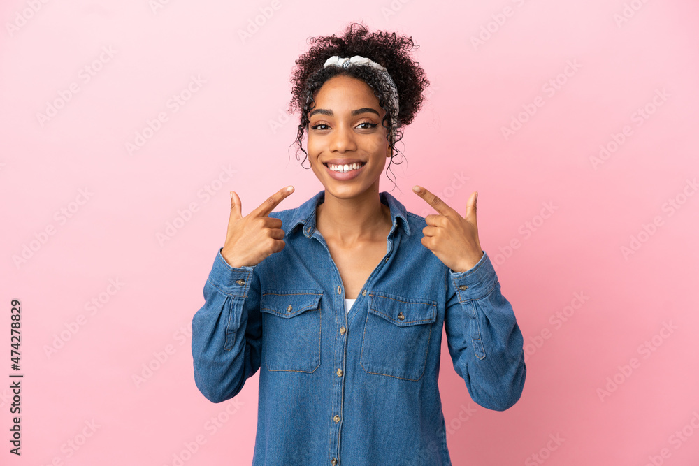 Young latin woman isolated on pink background giving a thumbs up gesture Young latin woman isolated on pink background giving a thumbs up gesture