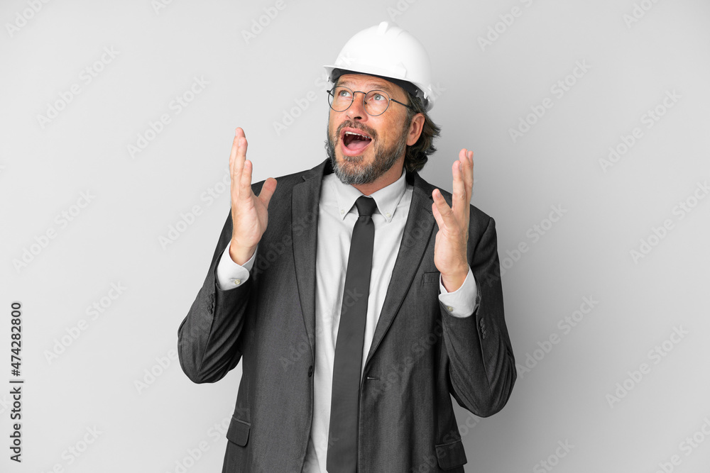 Young architect man with helmet over isolated background with surprise facial expression Young architect man with helmet over isolated background with surprise facial expression