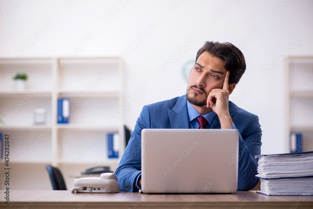 Young male employee working in the office Young male employee working in the office