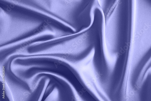 The color of 2022 is Very Perry. Beautiful smooth elegant wavy purple satin silk luxury fabric, fabric texture, abstract background design. Copy space