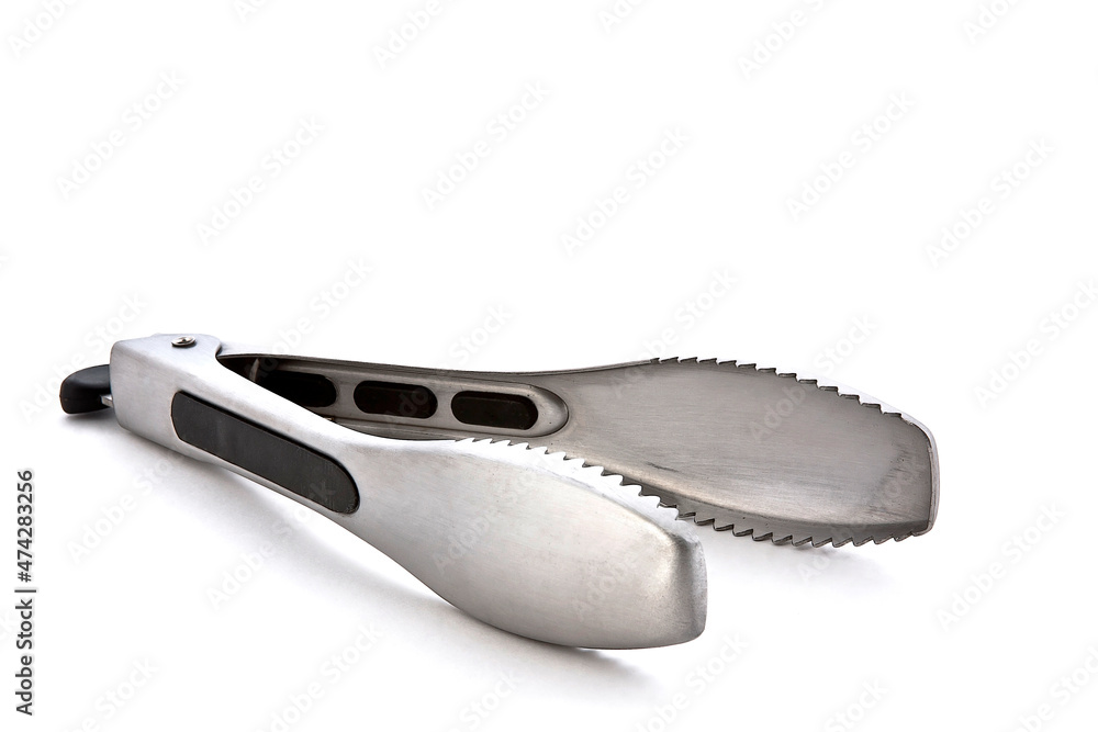 Metal kitchen tongs, stainless steel for serving, isolated on white background Metal kitchen tongs, stainless steel for serving, isolated on white background
