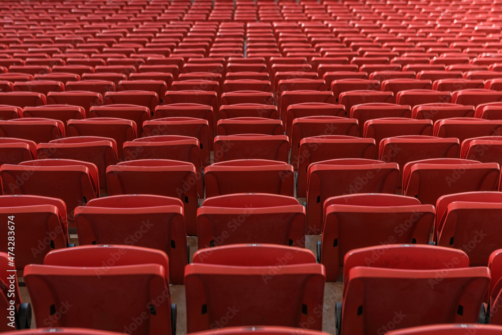 rows of red seats in a stadium rows of red seats in a stadium