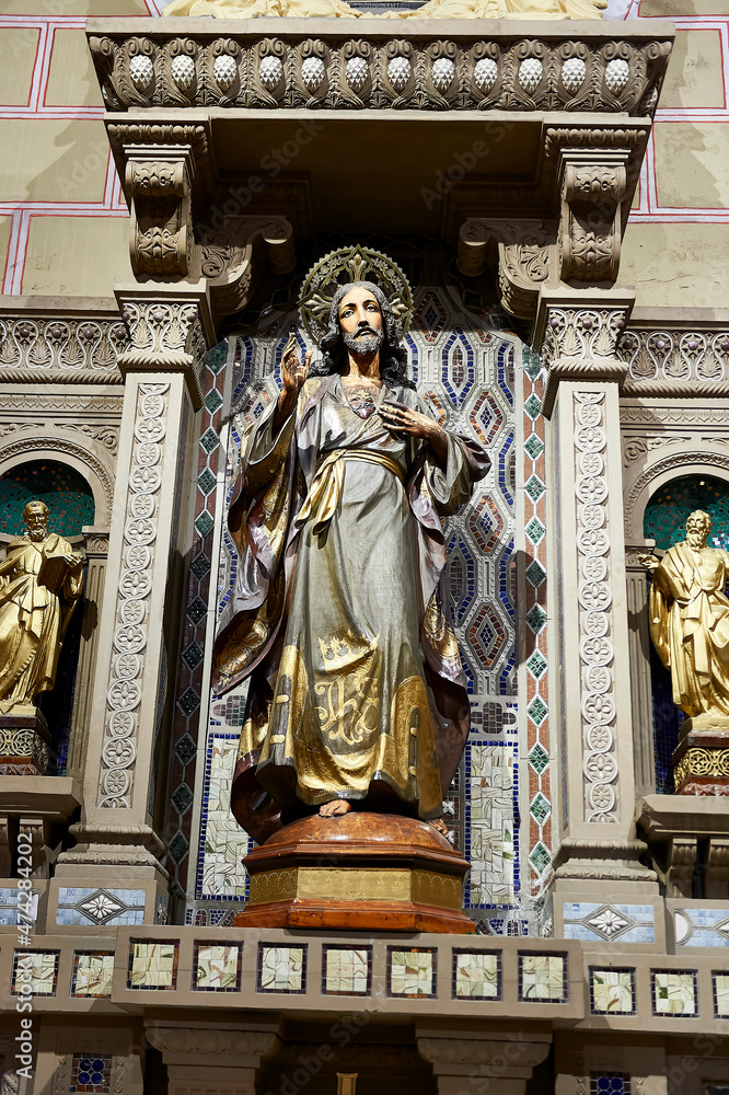 polychrome sculpture of the sacred heart of jesus
selective focus