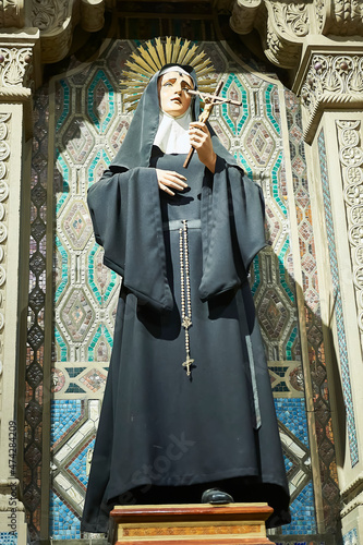 polychrome sculpture of saint rita of cassia
selective focus photo