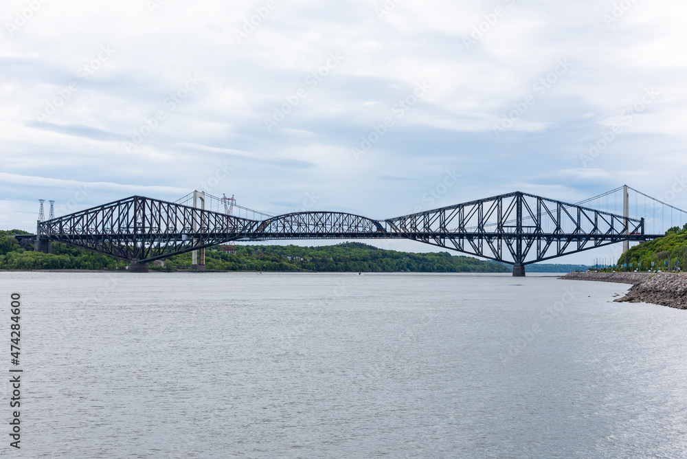 Obraz premium The two Quebec city bridge (Quebec bridge and Pierre-Laporte bridge) view from the north shore of the St Lawrence river in the district of Cap-Blanc Sillery