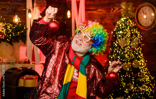 Mature man with white beard. Hocus pocus. Christmas spirit. Cheerful clown colorful hairstyle. Bearded senior man celebrate christmas. Party entertainment. Winter holidays. Christmas decorations home
