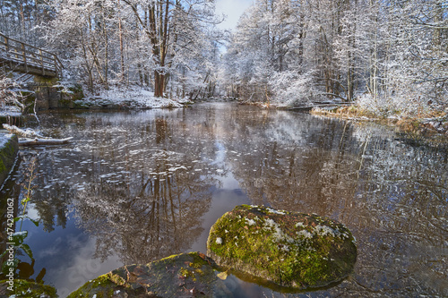 First snow on the forest rapids of Finnish Nukarinkoski: sunny October day. photo