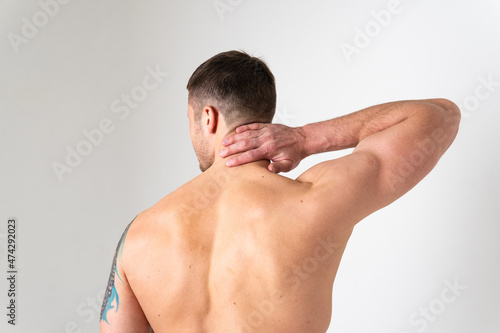 The muscles of the neck in a man on a white background are hurt pain hurt injury, cramp sick man young medical, illness chronic. Touching red care, lower suffer attractive