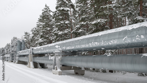 pipeline in the forest in winter. in the photo, the pipeline against the background of a winter forest and white snow