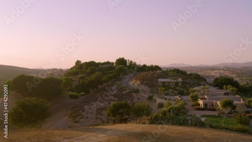Incredible footage of a natural scenic California vineyard, featuring rolling hills and vast views of incredible lush grapes against a backdrop of golden mountain ranges.