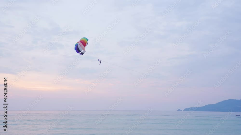 Tourists Kite surfing race slow motion flying on sky during sunset mountain background. Tourists Kite surfing race slow motion flying on sky during sunset mountain background.