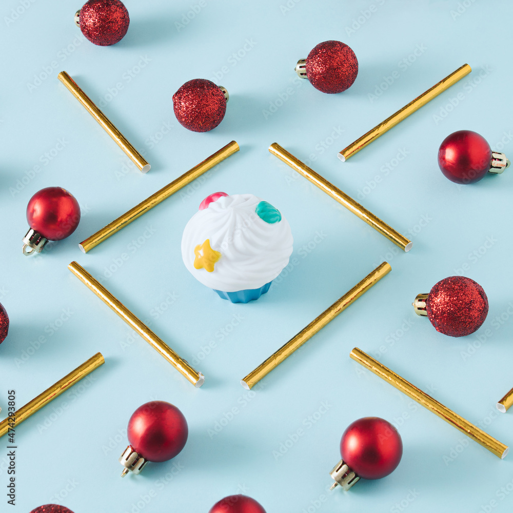Christmas creative arrangement with red baubles and gold straws on pastel blue background. Minimal New Year concept. Christmas creative arrangement with red baubles and gold straws on pastel blue background. Minimal New Year concept.