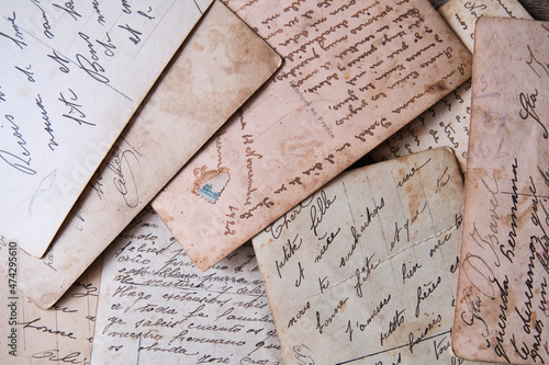 pile of old handwritten letters scattered on the table photo