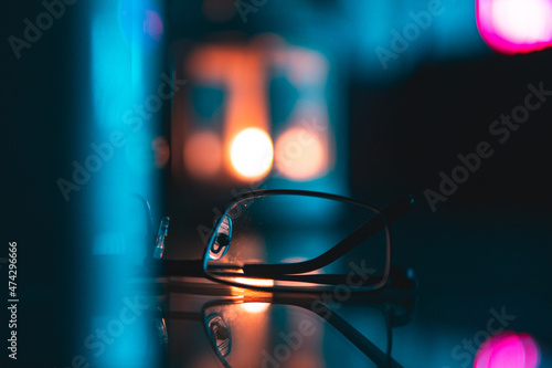 Glasses in blurred lights