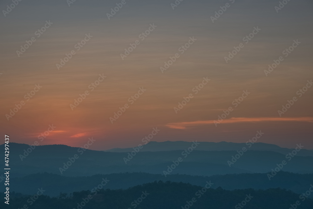 Colorful twilight sky  over a beautiful mountain range silhouette in an evening