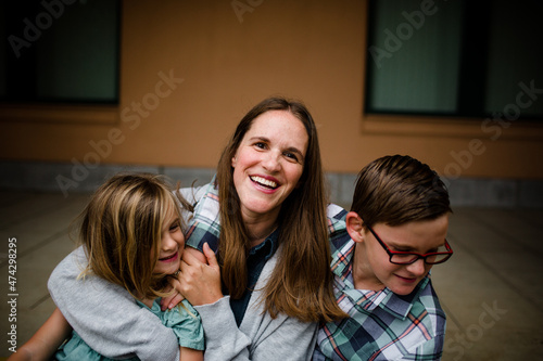 Mom Laughing & Embracing Kids in San Diego