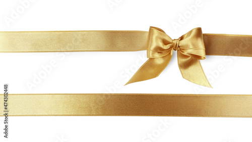 Photographie Beautiful golden ribbons with bow on white background, top view