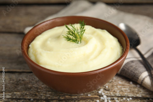 Freshly cooked homemade mashed potatoes and napkin on wooden table, closeup
