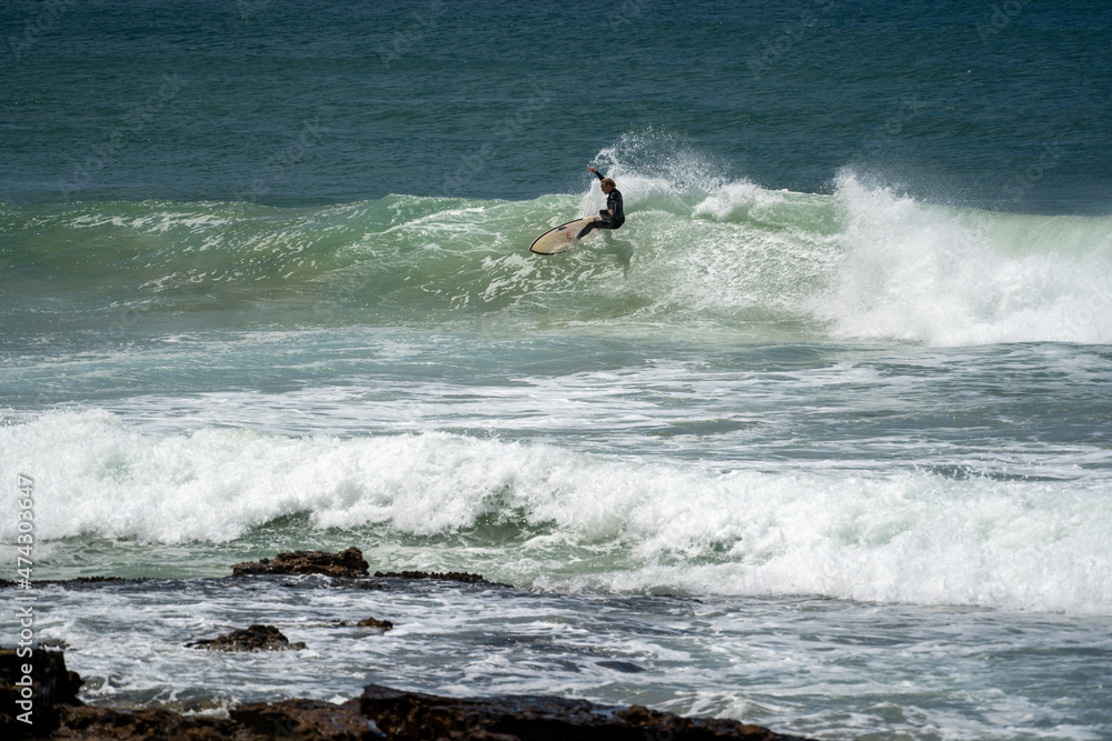 male surfer catching waves surfing at south coast beach on a bright warm sunny day on clear blue water male surfer catching waves surfing at south coast beach on a bright warm sunny day on clear blue water