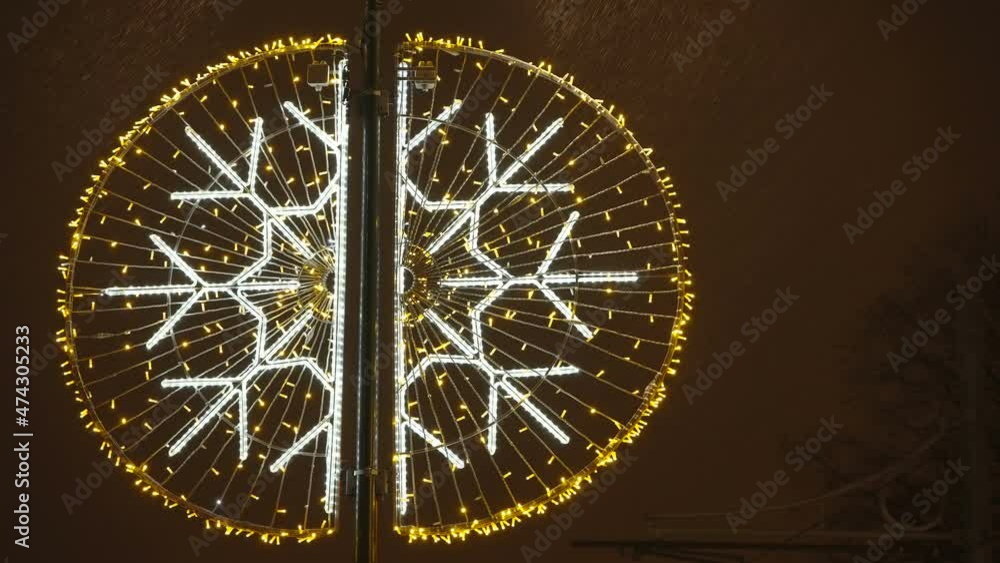 The yellow and white Christmas lights decor in the park during the holidays in Tallinn in Estonia The yellow and white Christmas lights decor in the park during the holidays in Tallinn in Estonia