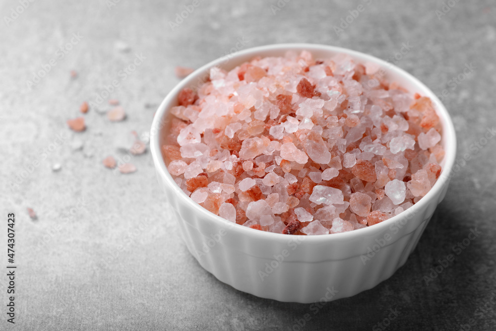 Pink Himalayan salt in bowl on grey table Pink Himalayan salt in bowl on grey table