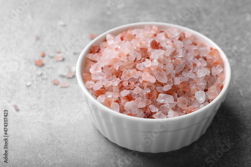 Pink Himalayan salt in bowl on grey table