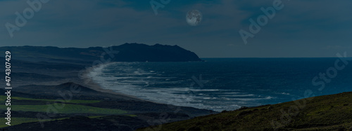 The moonlight shines on the coastline and creates a beautiful evening along the shore