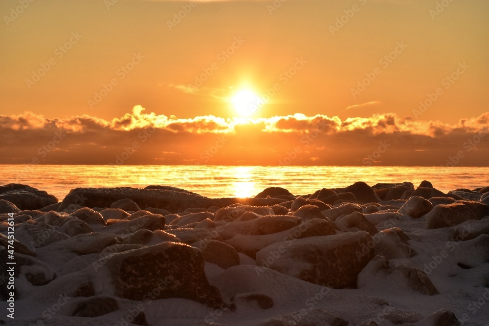 Snowy rocks sunrise over lake Snowy rocks sunrise over lake