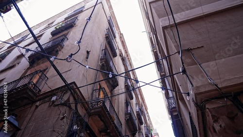 Cityscape of old narrow european alley between residential housing. Historic spanish center of Madrid or Seville. Medieval architecture. Steadicam shot