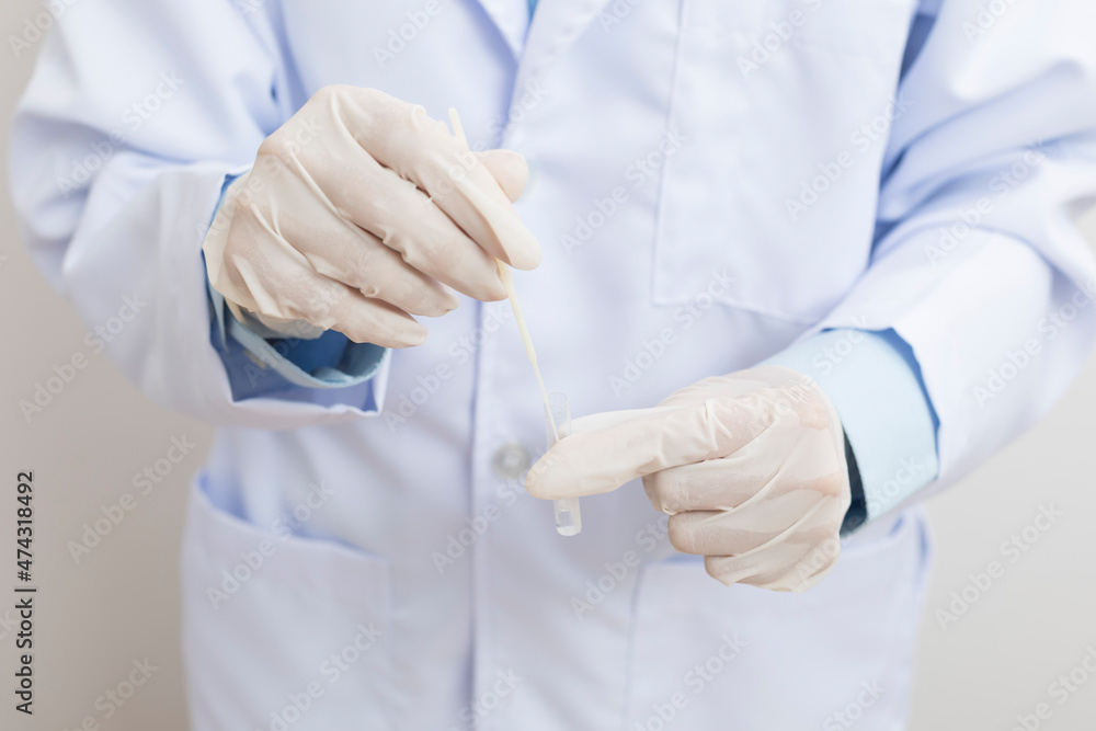 Medical personnel holding Antigen Test Kit (ATK) standing on white background. Medical personnel holding Antigen Test Kit (ATK) standing on white background.