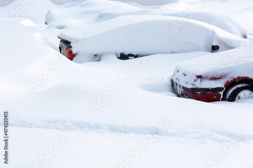 parking lot with cars buried in snowdrift after snowstorm. winter urban scene. © Mr Twister