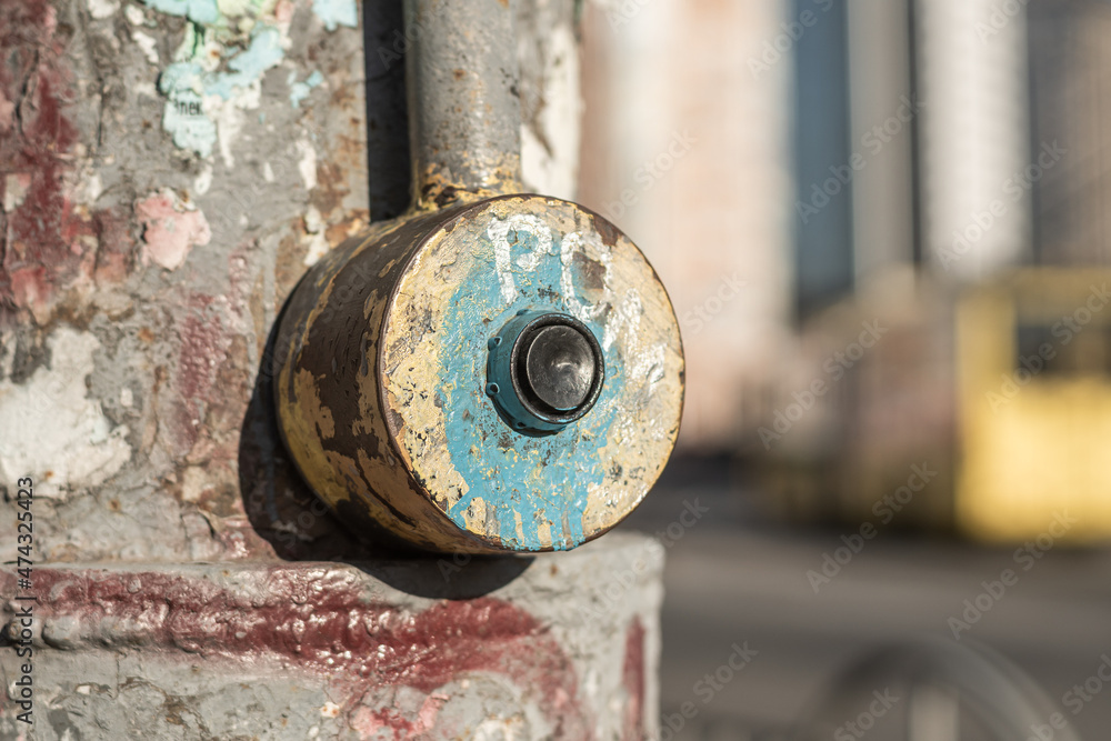Old dirty shabby button for switching traffic lights at a pedestrian crossing in the city, close up. Old dirty shabby button for switching traffic lights at a pedestrian crossing in the city, close up.