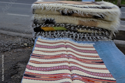 Yablunytsya pass, Ivano-Frankivsk oblast, Ukraine - Open Air Traditional Crafts Fair. Traditional Ukrainian patterns and designs made on woven products. Embroidery on the carpet. photo