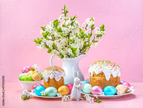 Easter composition on a pink background. Cherry flowers, cupcakes and Easter eggs. Spring concept